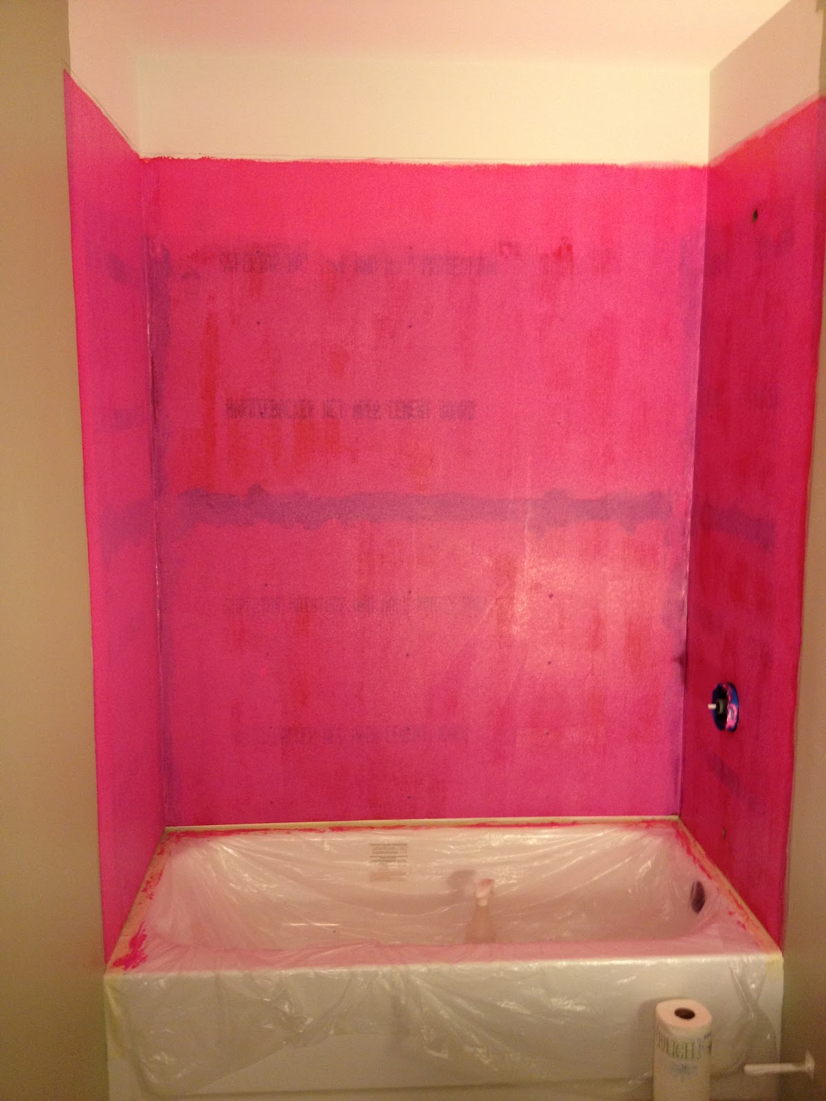 Shower renovation project showing cement board that has been prepped with waterproofing membrane prior to tile or stone installation